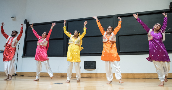Indian students performing a dance in colorful clothing